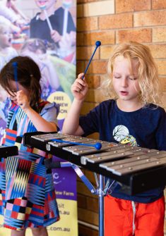 Two kids playing xylophones in kids music class