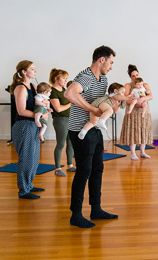 Parents holding babies in music classes